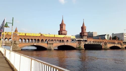 Trains on Oberbaum Bridge across River Spree on Summer Day in Berlin