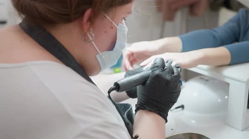 Nail Technician Working on Client's Nails