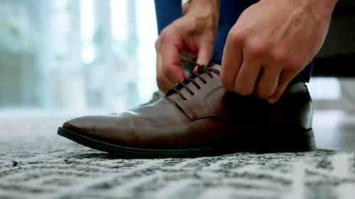 Man Tying Brown Leather Dress Shoes at Home