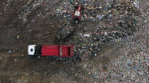 Aerial view of landfill with truck depositing waste