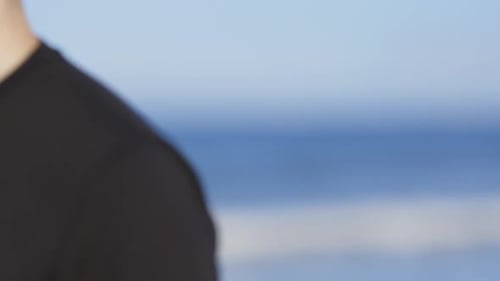 Athletic Man Running Barefoot on the Beach