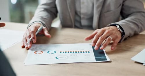 Adults Reviewing Charts and Graphs in Workplace