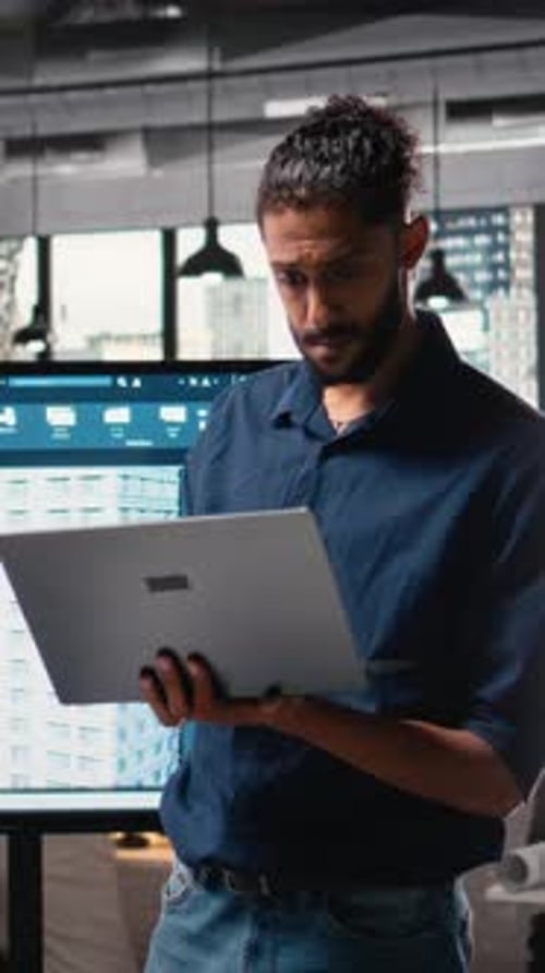 Man Working on Laptop in Modern Office
