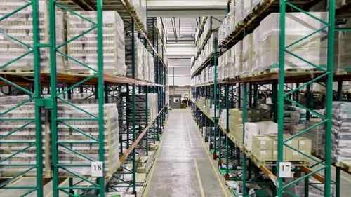 Warehouse Aisle with Shelves of Goods A Warehouse Aisle Lined with Tall Shelves Filled with Boxes