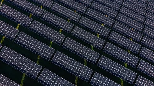 Flying over the multiple photovoltaic cells. Eco-friendly technology for green energy production.