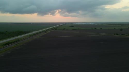 Aerial In Reverse Over Empty Texas, U.S.A., Field After Sunset