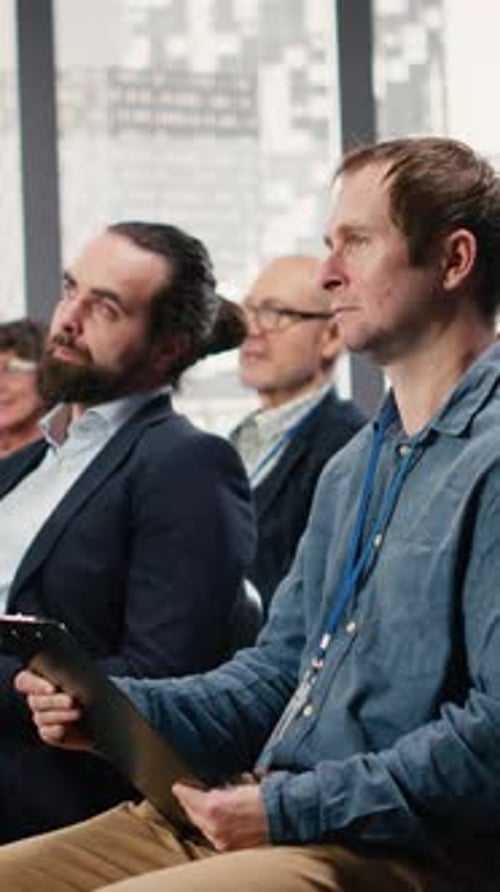 Vertical Video Corporate Conference Hall Filled with Chairs for Diverse Audience