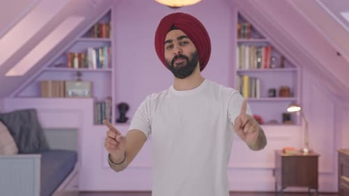 Happy Sikh Indian man dancing and doing Bhangra