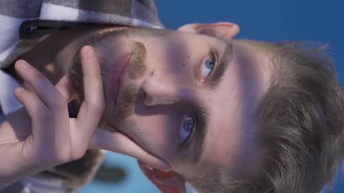 Man with Beard Leans On Hand