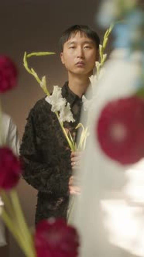 Motion Blur Footage of Asian Guy with Flowers and People Passing By