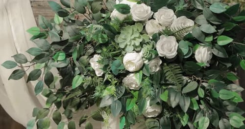 Close Up of White Roses and Green Leaves Decoration