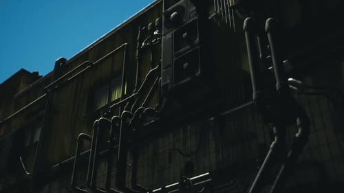 Urban Exploration of Industrial Building From Low Angle Under Clear Sky