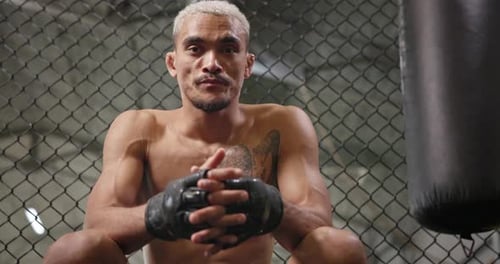 Intense Boxer Relaxing in Gym After Training