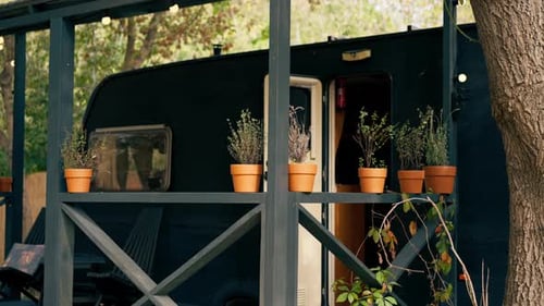 A mobile home with a terrace is located in country glamping site for relaxation and solitude nature