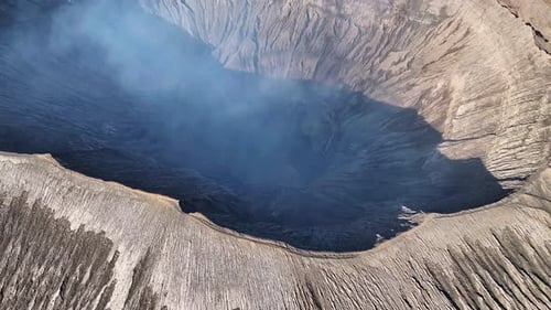 Mount Bromo, famous tourist destination in Java, Indonesia. Aerial reveal from middle of crater.