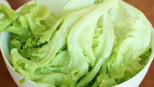 Lettuce Being Taken from Bowl Close Up