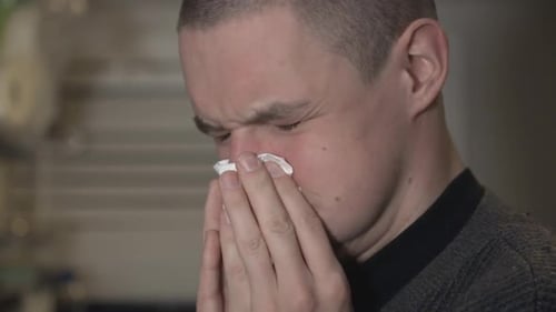 Adult Man Blowing Nose with Tissue Close Up