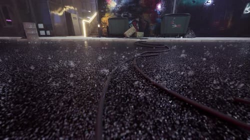 Wet Urban Street At Night With Reflections And Scattered Cables 4K