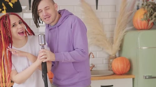 Singing a Duet with Microphone in Modern Kitchen