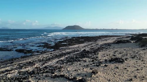 Aerial view of ocean waves and rocky shore, Spain.