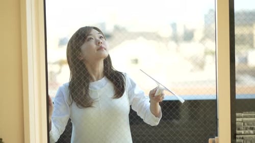 woman cleaning windows