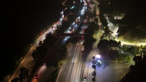 Cars And Trucks Driving On A Busy Hollywood Freeway At Night In Los Angeles, California.