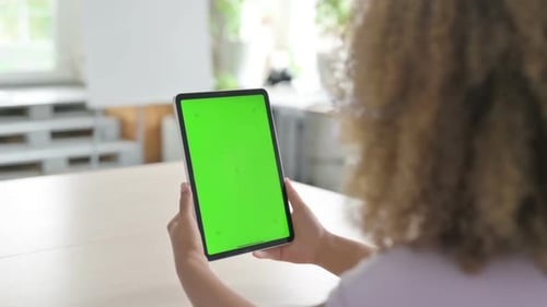 African Woman Using Digital Tablet with Green Screen