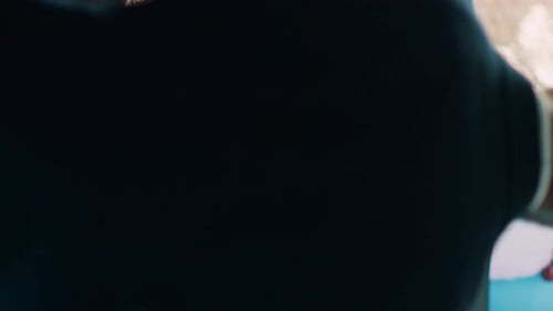 Woman Holds Red Dress in Clothing Store