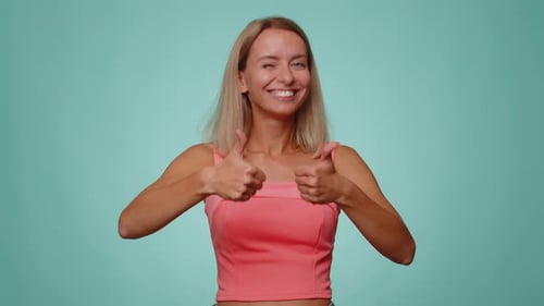 Lovely Woman Raises Thumbs Up Agrees or Gives Positive Reply Recommends Advertisement Likes Good
