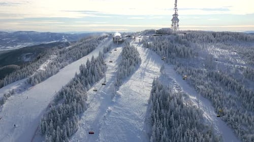 Aerial View of Snowy Ski Resort with Cable Cars and Winter Forest