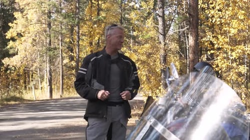 Motorcyclist Chatting Next to Motorbe in Forest Adult