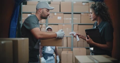 Logistics Distribution Warehouse Diverse Employees Unloading Delivery Truck with Cardboard Boxes
