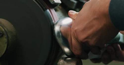 Macro of a shoemaker using a professional machine to bend the shoes and fix them according to the