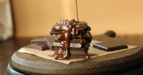 Delicious Chocolate Being Drizzled on Stacked Chocolate Bars