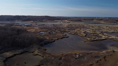 Wide panning aerial shot of salt marsh in Gloucester, Massachusetts.