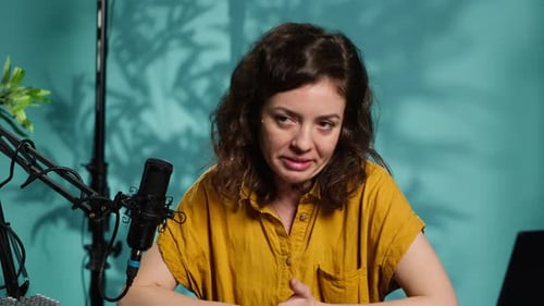 Woman Speaks into Microphone During Podcast