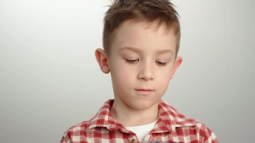 Young Boy Concentrating on a Smartphone Screen