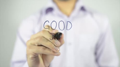 Adult Writes Good Job On Clear Surface