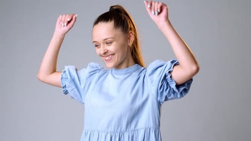 Cheerful Woman Celebrates Good News in Studio