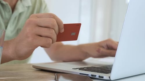 Typing Credit Card Data on Laptop Computer