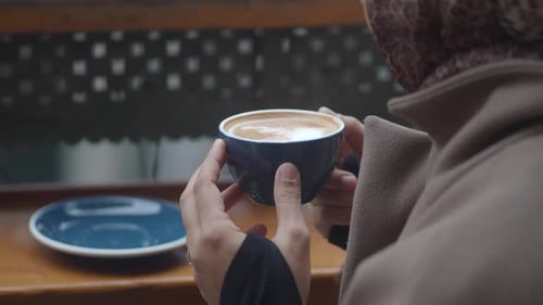 Enjoying Coffee in a Cozy Cafe Setting with Friends