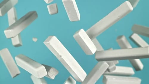 School Chalk Flying on a Blue Background Filmed on a Highspeed Camera at 1000 Fps