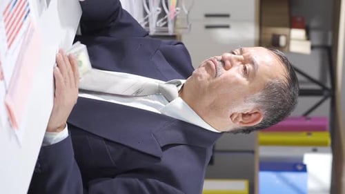 Man Counting Money in Office Setting