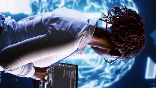 Woman Coding in Futuristic Blue Computer Lab