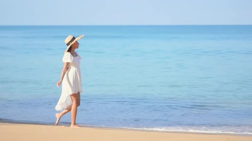 Happy Woman Walking Along Warm Sandy Beach
