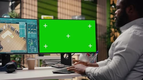 Green Screen and Architectural Software on Dual Monitors in Creative Agency