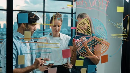 Business Team Brainstorming Ideas on Glass Whiteboard