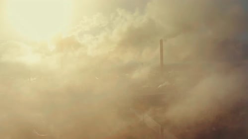 Power plant smokes. Aerial view of the power plant with smoking pipes and clouds passing by