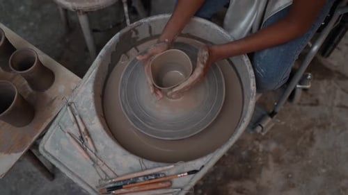 People Creating Pottery in Studio. Female artisan creating handmade ceramics in pottery workshop