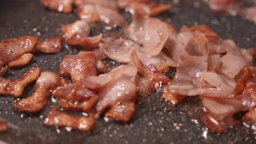 Delicious Bacon Frying on a Non-Stick Pan